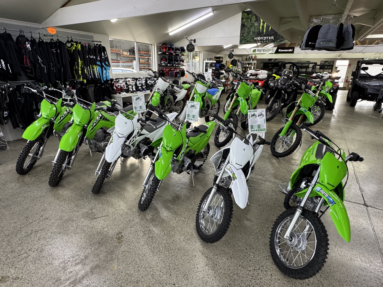 Green Kawasaki dirt bikes on the showroom floor