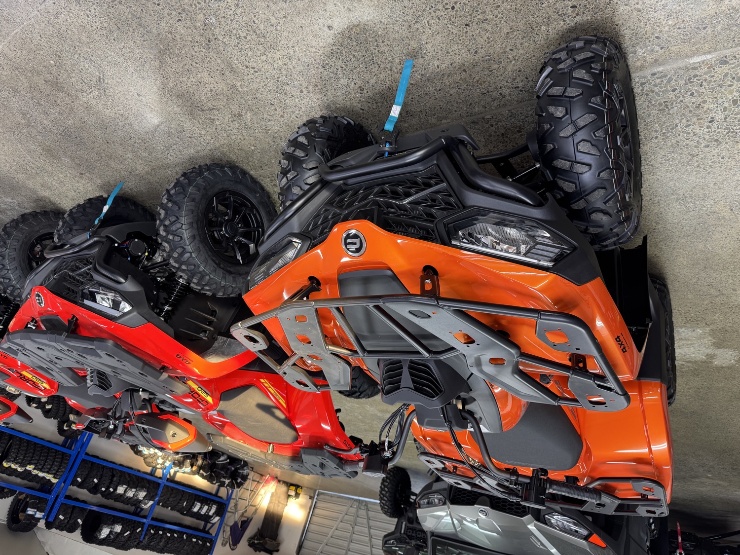 Orange CF Moto quads on the showroom floor